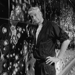 A portrait photograph of Maurizio Cattelan