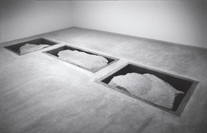 Michael Heizer, Displaced/Replaced Mass (3), 1994. 20-ton white granite boulder and 2 15-ton white granite boulders in concrete pits, in 3 parts, part a: 17 feet × 6 feet 6 inches × 8 feet (5.2 × 2 × 2.4 m), parts b and c, each: 10 feet × 12 feet × 3 feet (3.1 × 3.7 × .9 m), installed at Ace Gallery, New York, July 1–August 15, 1994, Inhotim Collection, Brazil © Michael Heizer