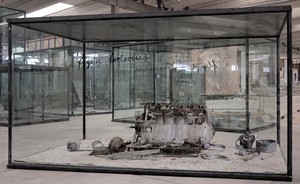 Anselm Kiefer, Flying Fortress, 2010. Airplane engine, steel, photographs, lead, and oil, emulsion, acrylic, and shellac on clay on canvas, in inscribed glass and steel vitrine, 94 ½ × 169 ¼ × 90 ⅝ inches (240 × 430 × 230 cm) © Anselm Kiefer