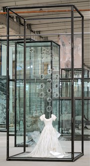 Anselm Kiefer, Die Schechina, 2010 Painted resin dress, glass shards, steel, numbered glass disks, and wire, in inscribed glass and steel vitrine, 179 ⅛ × 82 ¾ × 82 ¾ inches (455 × 210 × 210 cm)© Anselm Kiefer