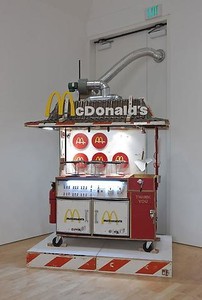 Tom Sachs, Salt the Fries, 2005–09. Plywood, synthetic polymer, hardware, wires, friers, lighting system, fridges, casters, plexiglass, steel, and wood barriers, 100 × 70 × 48 inches (254 × 177.8 × 121.9 cm) Photo: Josh White