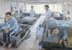 Figures in hospital-like setting where bed are old cars