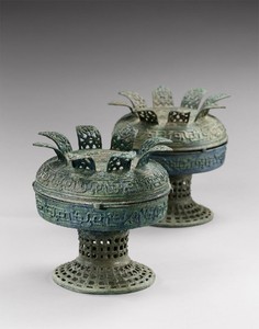 Archaic vessels with petalled covers (dou), early Spring and Autumn period (770–481 BCE). Bronze, set of 2; each, height: 9 ⅞ inches (25 cm) Inscriptions inside each vessel and cover Photo: Frédéric Dehaen, Studio Roger Asselberghs
