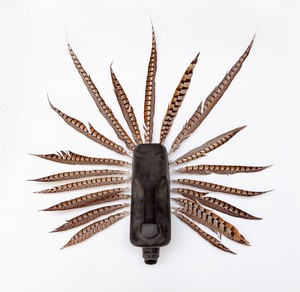 Romuald Hazoumè, Curazao, 2018. Plastic and pheasant feathers, 33 ⅛ × 30 ¾ × 8 ¾ inches (84 × 78 × 22 cm) © 2018 Romuald Hazoumè and Artists Rights Society (ARS), New York/ADAGP, Paris. Photo: Zarko Vijatovic