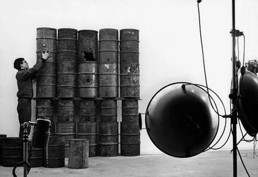 Christo erecting 26 Oil Barrels (1961) in Jean-Dominique Lajoux’s studio, Paris, 1961.
