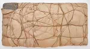 Christo, Package, 1961. Fabric, polyethylene, rope, and twine, 33 ⅛ × 65 × 13 ¾ inches (84 × 165 × 35 cm) © Christo and Jeanne-Claude Foundation. Photo: Thomas Lannes