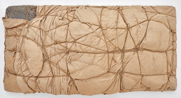 Christo, Package, 1961 Fabric, polyethylene, rope, and twine, 33 ⅛ × 65 × 13 ¾ inches (84 × 165 × 35 cm)© Christo and Jeanne-Claude Foundation. Photo: Thomas Lannes