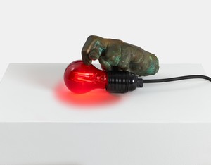 Douglas Gordon, The hand that held the hand that held, 2016–22. Bronze, light bulb, and cable, 4 ⅜ × 3 ⅛ × 7 ⅞ inches (11 × 8 × 20 cm) © Studio lost but found/VG Bild-Kunst, Bonn, Germany, 2022. Photo: Prudence Cuming Associates Ltd.