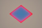A large triangular cut-out by James Turrell with vibrant colors