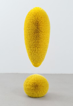 Yellow exclamation point made of plastic bristles around five and half feet tall