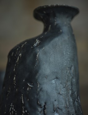 Detail of a stoneware vessel with black glaze