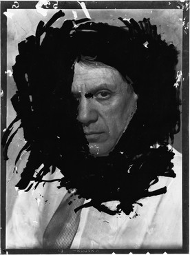 Photograph of Pablo Picasso with a ring of black around his facing, obscuring one eye