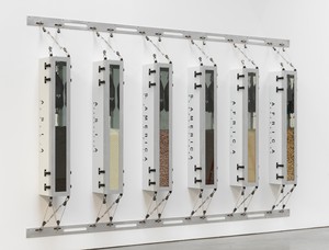 Ashley Bickerton, Minimalism’s Evil Orthodoxy/Monoculture’s Totalitarian Aesthetic, 1989/2023. Metal boxes, rocks, rice, peanuts, and water bags, overall: 96 × 155 ¾ × 12 ¼ inches (243.8 × 395.6 × 31.1 cm), 1 of 5 unique versions © Ashley Bickerton. Photo: Rob McKeever