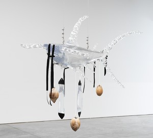 Ashley Bickerton, Clear Shark (Holy), 2008/2023. Resin, polyvinyl, netting, straps, water bags, and coconuts, 77 × 108 × 58 inches (195.6 × 274.3 × 147.3 cm), 1 of 5 unique versions © Ashley Bickerton. Photo: Rob McKeever