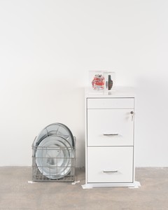Cady Noland, Untitled, 2023. Metal filing cabinet with key, Coca-Cola can and hand grenade in cast acrylic, metal basket, aluminum trash can lids, and tape, 33 ½ × 30 ¼ × 18 ½ inches (85.1 × 76.7 × 47 cm) © Cady Noland. Photo: Owen Conway
