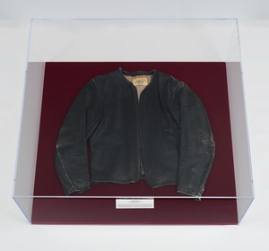 Chris Burden, Atomic Alphabet, 1979. Leather jacket in Plexiglas and velvet vitrine, 11 × 36 × 33 inches (27.9 × 91.4 × 83.8 cm) © 2023 Chris Burden/Licensed by the Chris Burden Estate and Artists Rights Society (ARS), New York. Photo: Rob McKeever