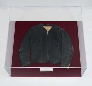 Chris Burden, Atomic Alphabet, 1979 Leather jacket in Plexiglas and velvet vitrine, 11 × 36 × 33 inches (27.9 × 91.4 × 83.8 cm)© 2023 Chris Burden/Licensed by the Chris Burden Estate and Artists Rights Society (ARS), New York. Photo: Rob McKeever