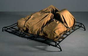 Christo, Package on a Luggage Rack, 1962. Tarpaulin, rubber-coated rope, and metal luggage rack, 24 ⅞ × 59 ⅛ × 42 ⅛ inches (63 × 150 × 107 cm) © Christo and Jeanne-Claude Foundation. Photo: Eeva-Inkeri