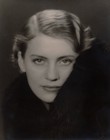 Black-and-white headshot of Lee Miller looking directly at the camera