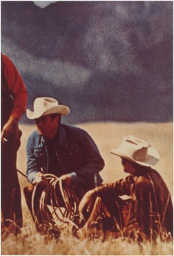 Three cowboys in a field