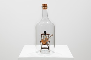 Maurizio Cattelan DEAF, 2025. Glass, bronze, wood, cork, silver, and fabric, 11 ⅝ × 4 ⅝ × 4 ⅝ inches (29.5 × 11.8 × 11.8 cm), edition of 10 + 2 AP © Maurizio Cattelan. Photo: Zeno Zotti