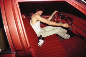Nan Goldin Mark in the red car, Lexington, Mass. (1979) from The Ballad of Sexual Dependency, 1973–86. 126 archival pigment prints, in frames, each: 15 ¾ × 11 × 1 ⅛ inches (40 × 27.9 × 2.9 cm), overall dimensions variable, edition of 10 © Nan Goldin
