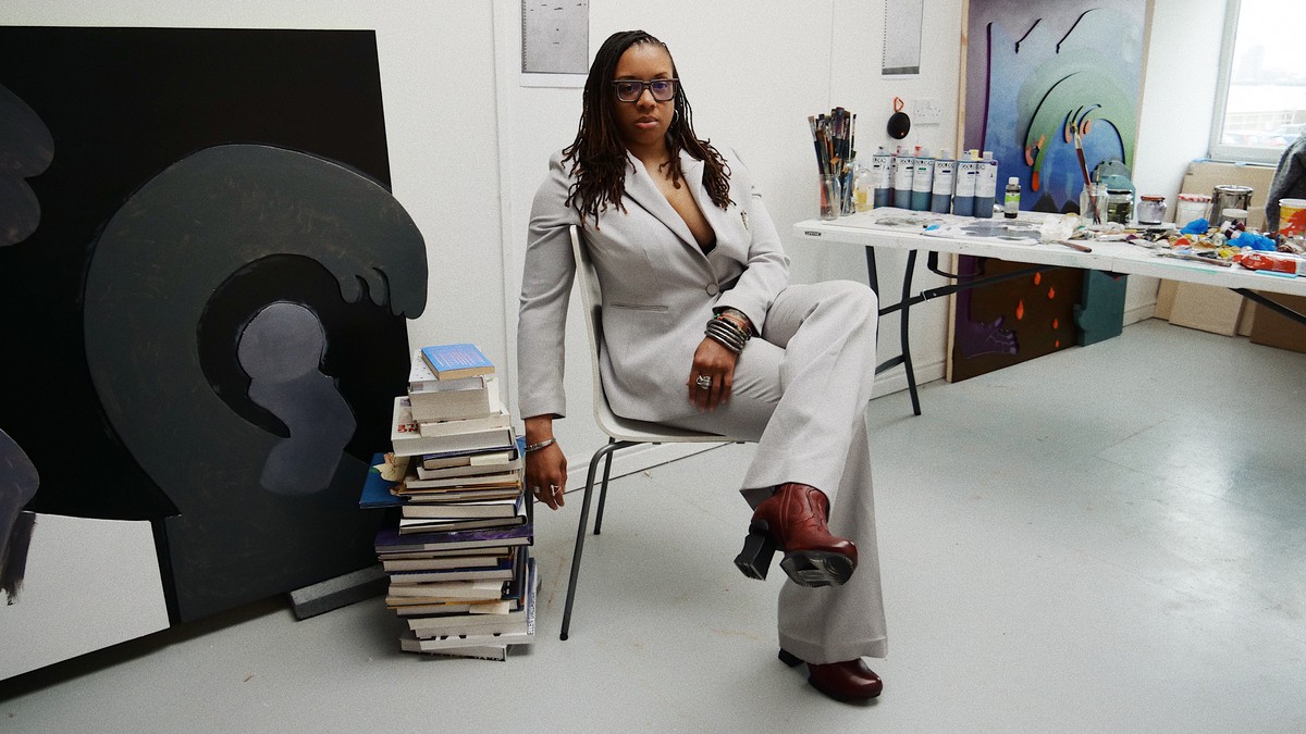 Artist Alexandria Smith sitting on a chair in her studio