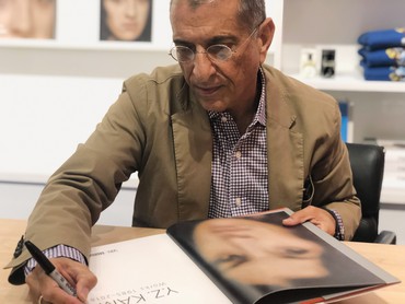 Y.Z. Kami signing a copy of his monograph at the Gagosian Shop, New York, 2019
