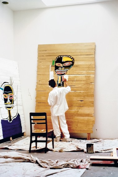 Jean-Michel Basquiat with Gold Griot (1984) and M (1984) in his studio at 21 Market Street, Venice, California, spring 1984. Artwork © The Estate of Jean-Michel Basquiat. Licensed by Artestar, New York. Photo: B.Dub/Brian D. Williams