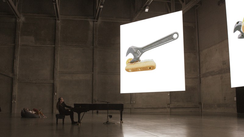 Pete Drungle performing on the piano inside Urs Fischer’s exhibition of digital sculptures at Marciano Art Foundation in Los Angeles