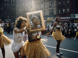 People part of a parade dance down the street
