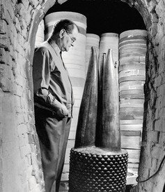 Axel Salto looking at the sculpture The Core of Power in the kiln, 1956