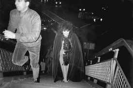 Black and white image of Annie Flanders entering Area nightclub, New York, 1986.