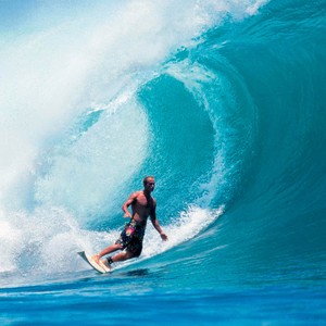 <p>Ashley Bickerton surfing in Padang Padang, Bali, c. 2006. Photo: courtesy Bickerton Studio</p>