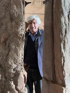Portrait of Giuseppe Penone standing in between his artworks