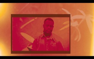 Film still from "Keith LaMar: SWEET" (2024) features a portrait of a person with a frame, overlayed with an orange and red color filter