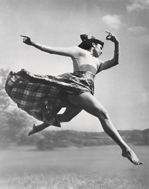 Black and white portrait of Katherine Dunham leaping in the air