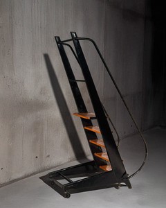 Jean Prouvé, Rolling Stepladder, c. 1950, lacquered steel structure, solid wood steps, and metal swivel casters. Model ordered by Société Générale, specifically designed for use in vaults to access overhead lockers