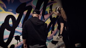 Graffiti artists Faust and Vexta painting a wall
