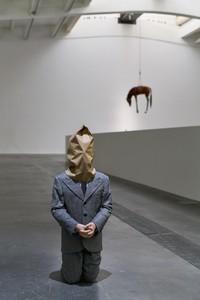 <p>Maurizio Cattelan, <em>No</em>, 2021, silicone rubber, natural hair, clothing, boots, and paper bag, 39 ¾ × 16 ⅛ × 17 inches (101 × 41 × 43 cm)</p>