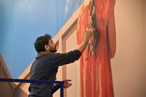 <p>Mehdi Ghadyanloo working on <em>Finding Hope</em> (2019), a mural in the lobby of the Congress Centre for the Annual Meeting of the World Economic Forum, Davos, Switzerland, 2019. Photo: Jack Hardy</p>