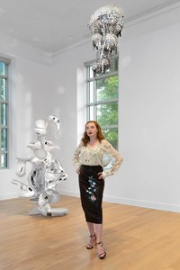 Rachel Feinstein stands in a gallery where a couple of her works are presented