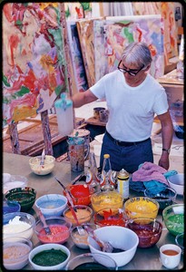 Willem De Kooning in his studio in East Hampton, New York. He is surrounded by bowls of different colored paints