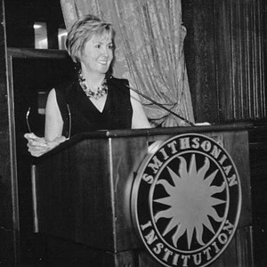 Black-and-white image of Wendy Jeffers standing at a podium
