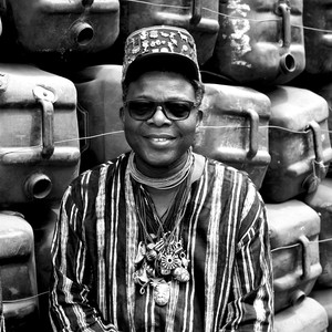 Black and white portrait of Romuald Hazoumè