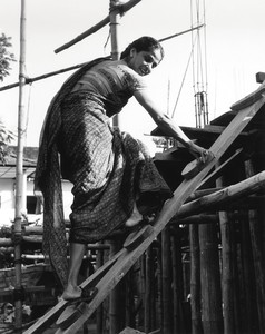 <p>Minnette De Silva climbing up to inspect concrete pillars and slab work at the De Saram house, Colombo, Sri Lanka, 1951. Photo: RIBA Collections</p>