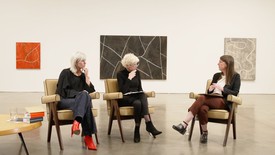 Marta Kuzma, Eileen Costello, and Caitlin Murray in conversation surrounded by Donald Judd paintings.