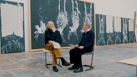 Georg Baselitz and Richard Calvocoressi sit next to each other in the artist’s studio