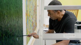 Rick Lowe painting in his studio.