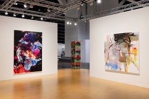 Installation view of artworks hanging in a booth
